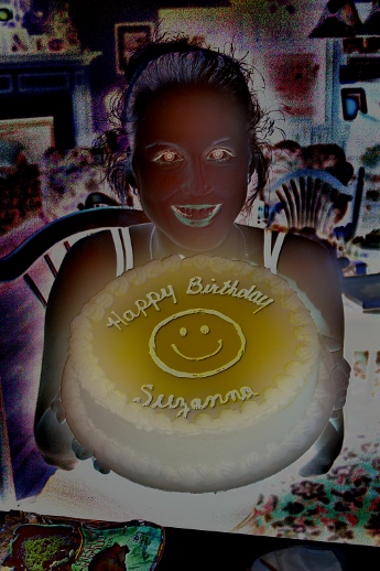 An image of Suzanna holding a birthday cake, but with inverted colors.